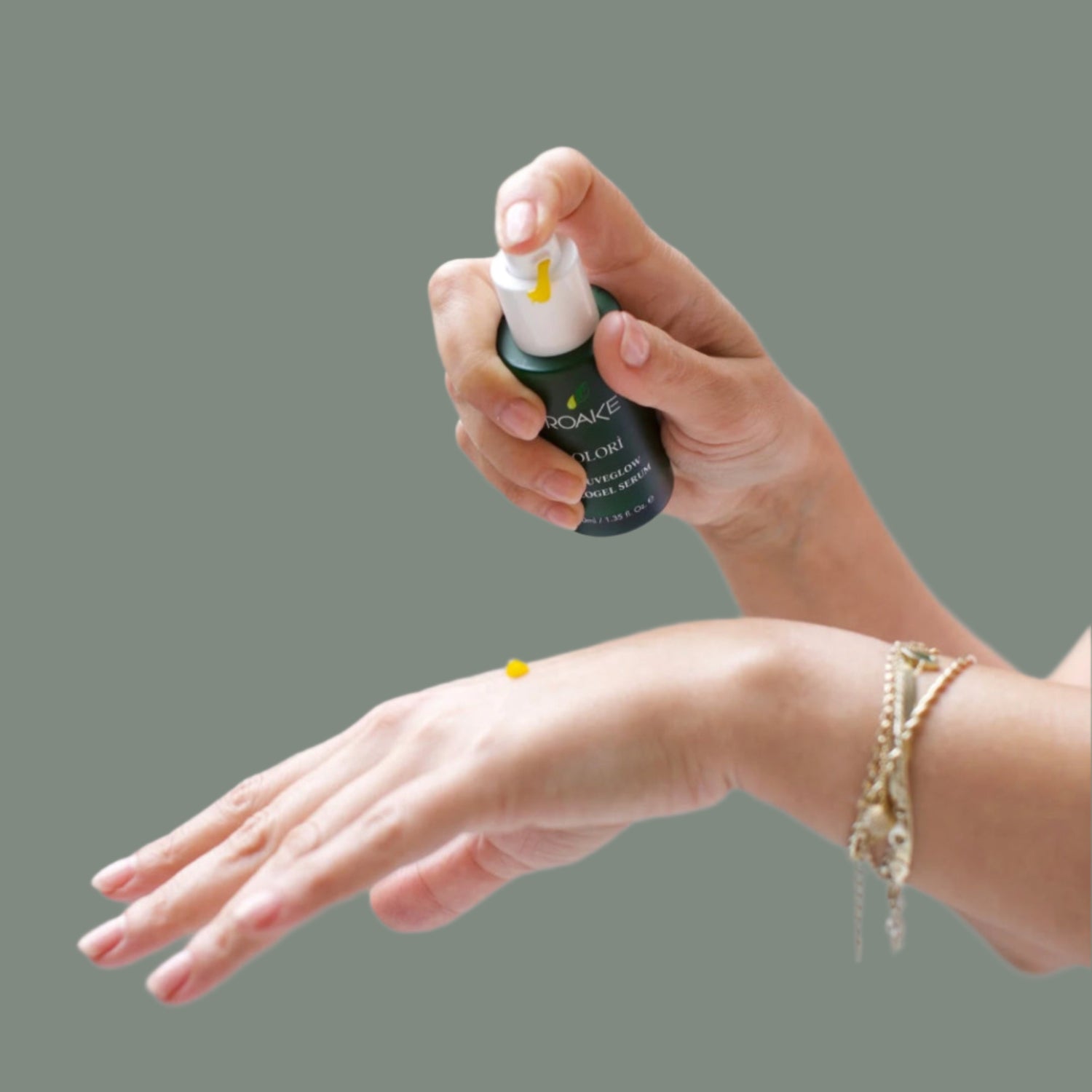  Olorì RejuveGlow Serum on the back of a woman’s hand.